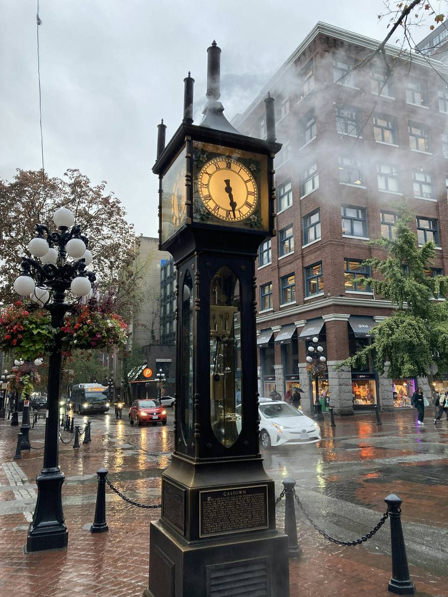 The Gastown steam clock with steam rising on a rainy day in Vancouver