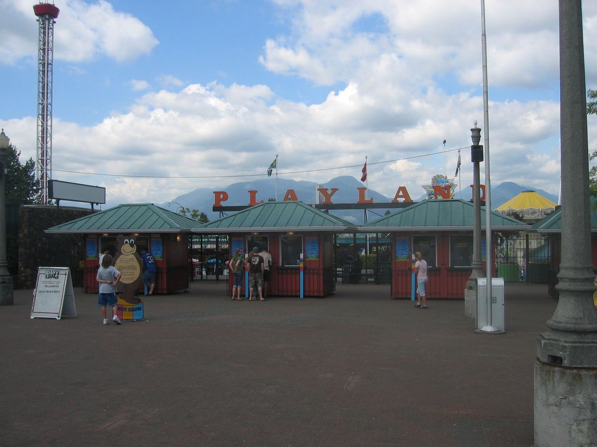 Playland amusement park entrance in Vancouver with the iconic sign and North Shore mountains behind
