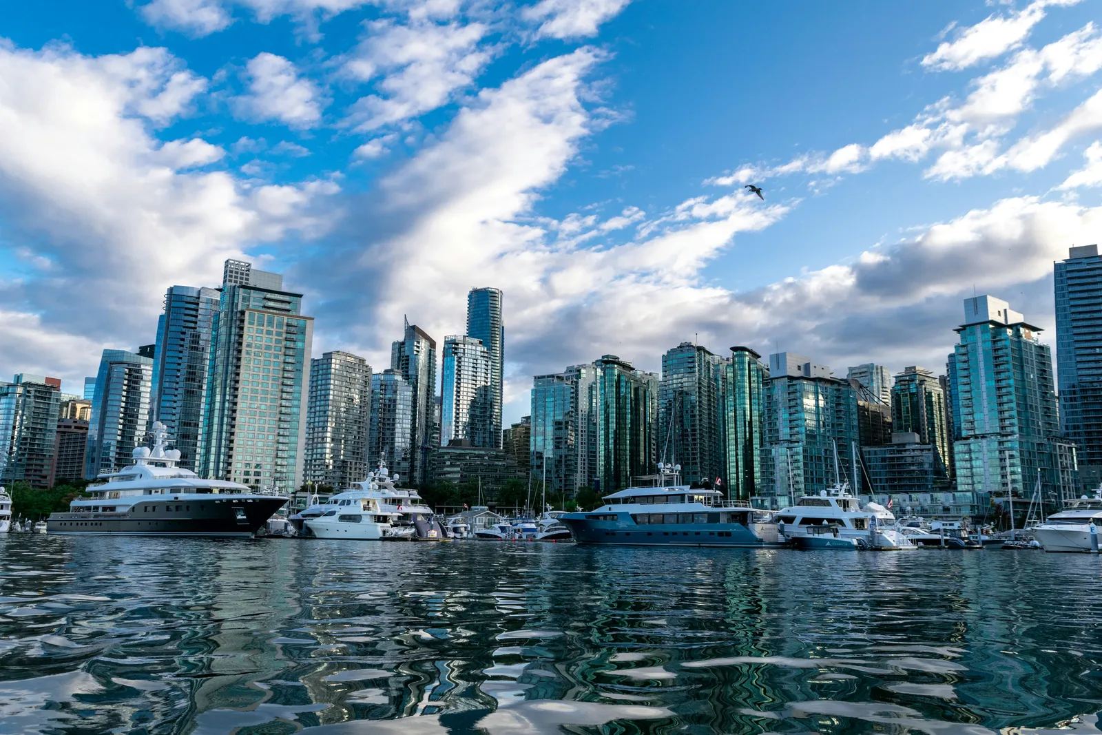 Downtown Vancouver skyline viewed from the water, with the North Shore mountains in the background.