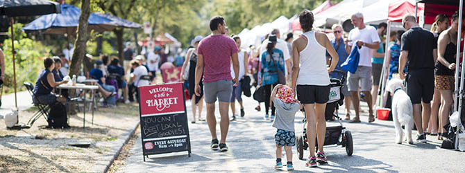 Families and shoppers at a Metro Vancouver farmers market on a sunny summer morning