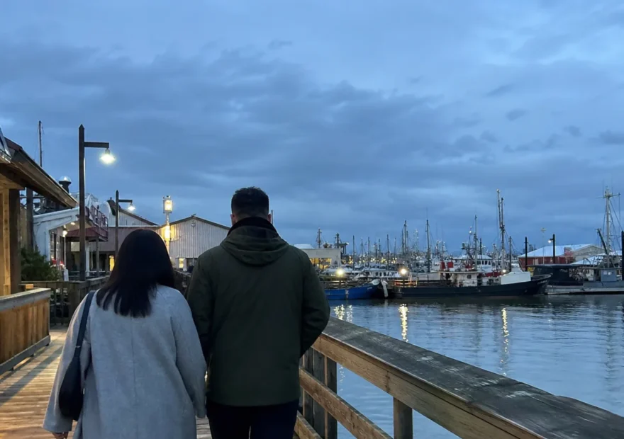Couple walking along the Steveston waterfront on a Richmond date night