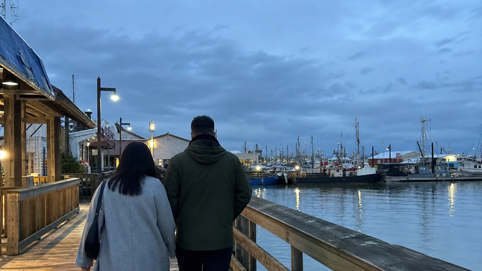 Couple walking along the Steveston waterfront on a Richmond date night