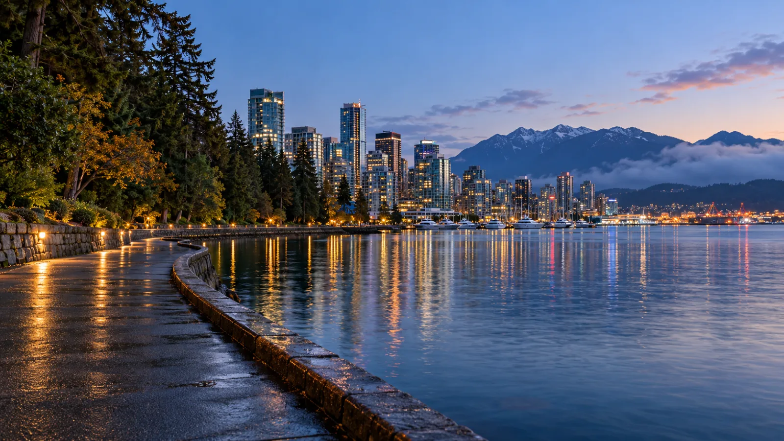 Stanley Park seawall and Vancouver skyline at blue hour